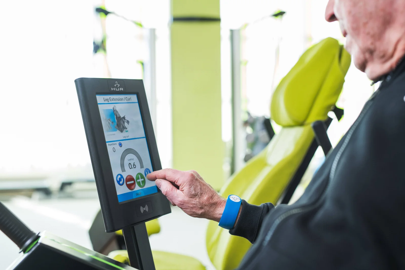 An exerciser selecting a programme on a HUR SmartTouch screen